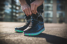 Load image into Gallery viewer, Man doing up his LED high top running shoes